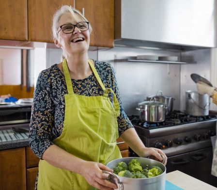Photo of an older female chatting with a navigator in her home